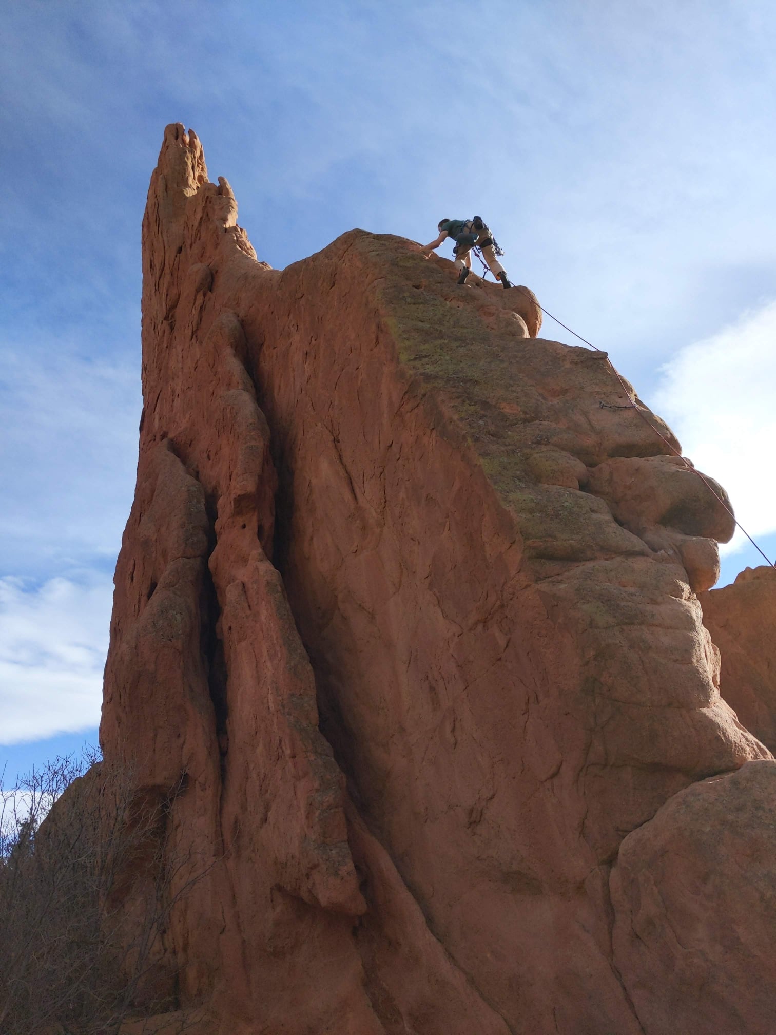 a rock climbing at the top of a mountain